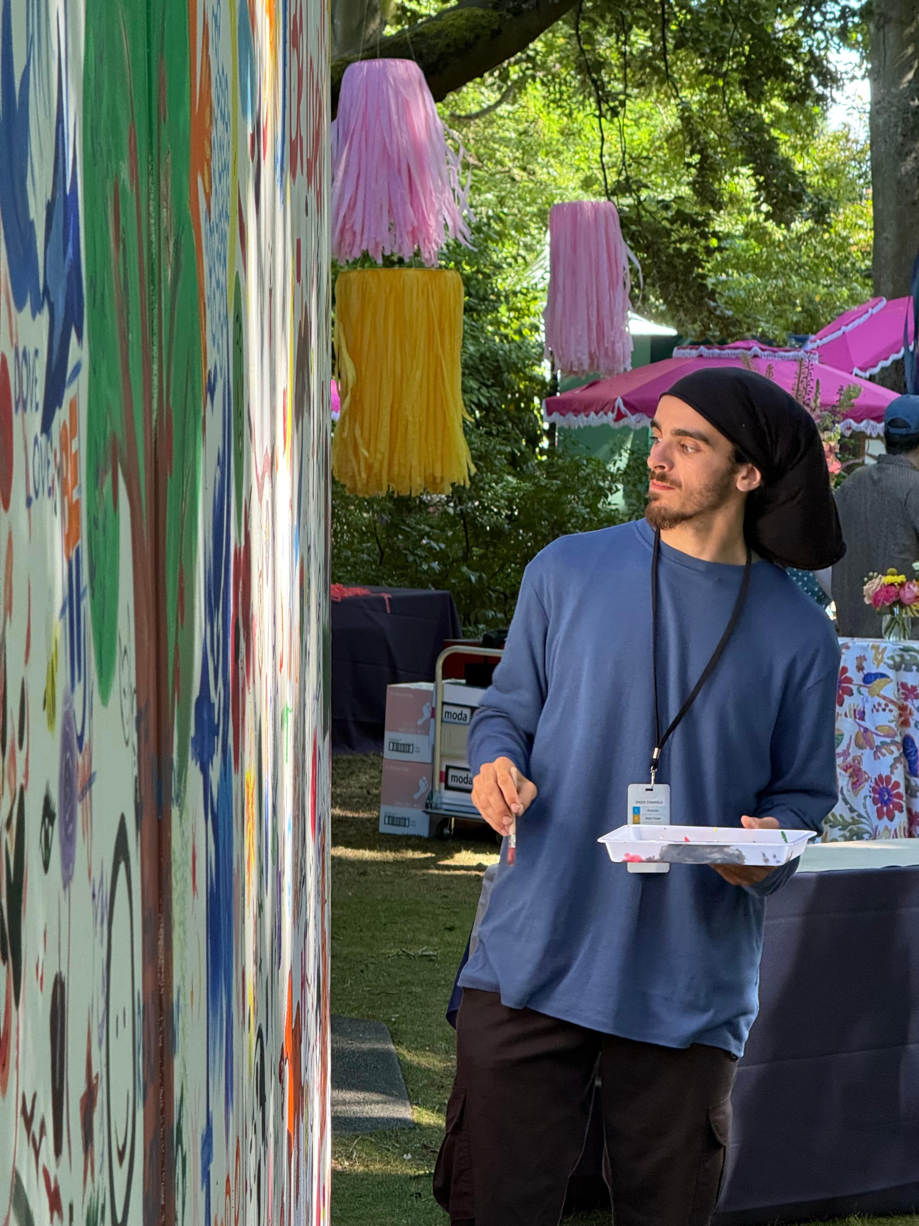 Jayden Jackson painting a collaborative outdoor mural