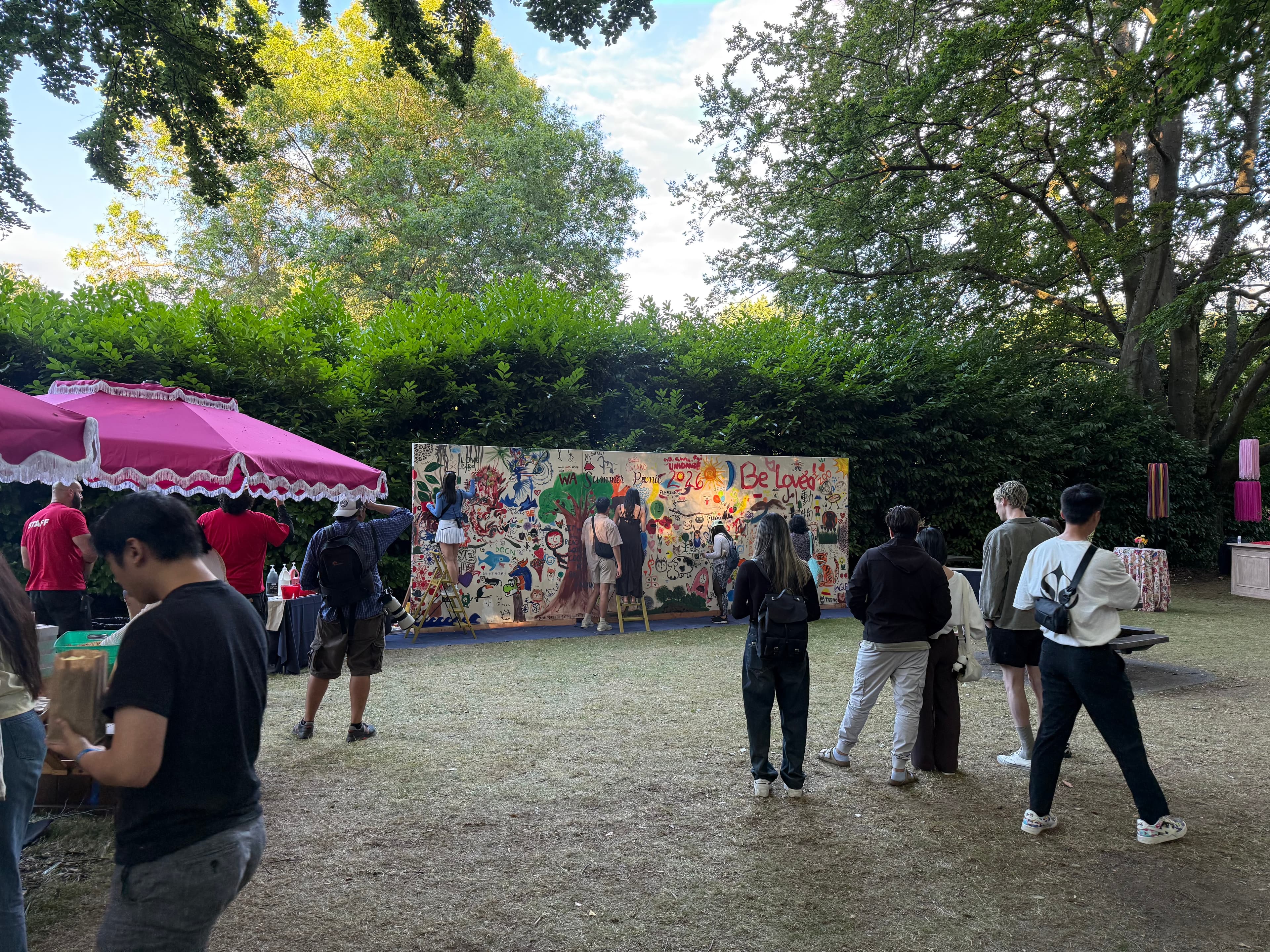 As the event comes to a close, participants take in the piece they created together, reflecting a shared sense of community and teamwork.